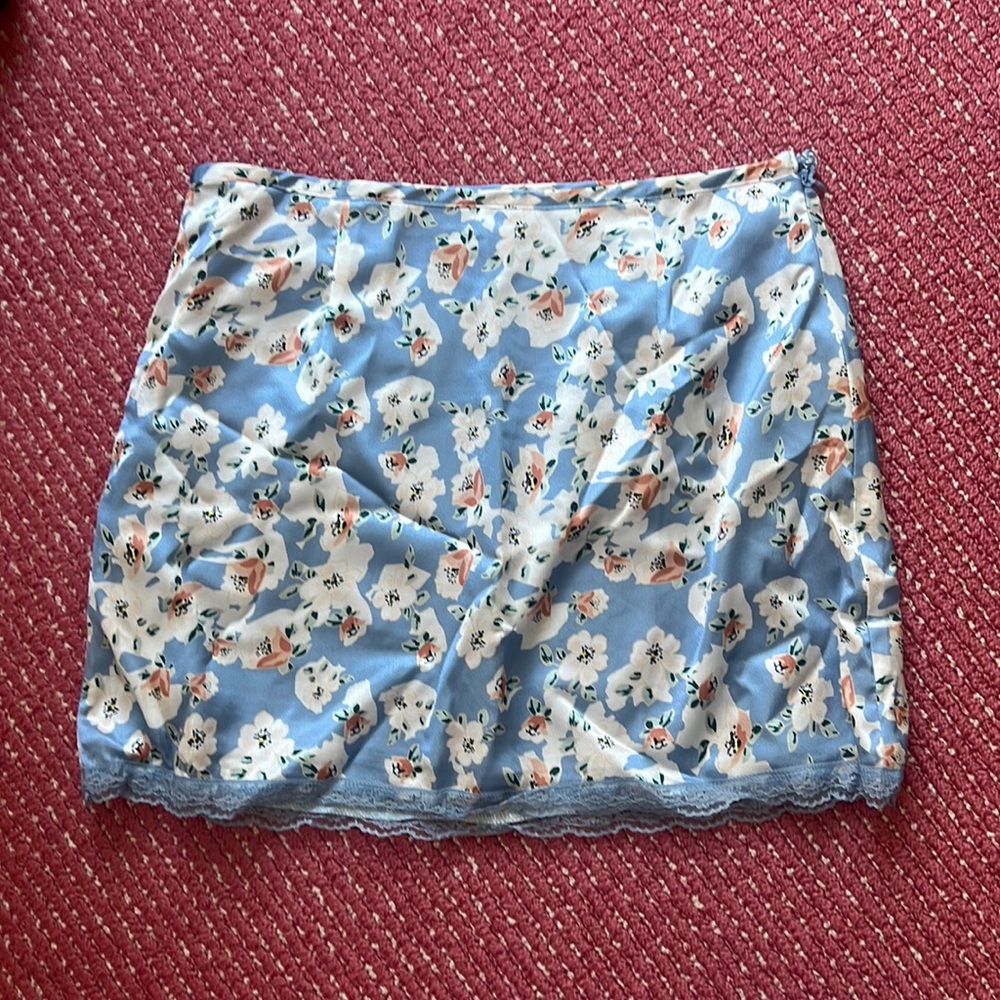 More to Come super cute floral/coastal blue skirt with lace detail on the bottom